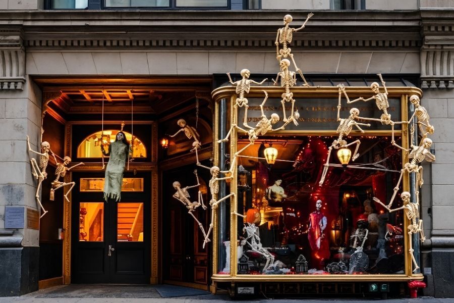 Costumed guests at a busy restaurant table on Halloween night in Manhattan